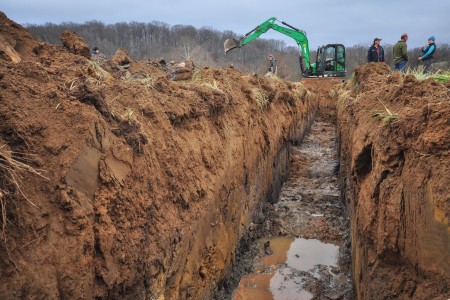 An excavator removes legacy sediment, the accrual of centuries-old dams. 
